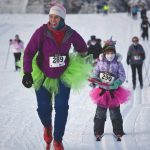 Carly Reimer tows daughter, Lois, at the 17th Ski for Women on Sunday, Feb. 7, 2021, at Tsalteshi Trails just outside of Soldotna, Alaska. (Photo by Jeff Helminiak/Peninsula Clarion)