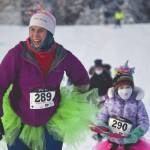 Carly Reimer tows daughter, Lois, at the 17th Ski for Women on Sunday, Feb. 7, 2021, at Tsalteshi Trails just outside of Soldotna, Alaska. (Photo by Jeff Helminiak/Peninsula Clarion)