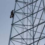 Billy Adamson scales a communications tower on Thursday, Jan. 7 in Nikiski, Alaska. (Ashlyn OHara/Peninsula Clarion)