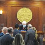 Alaska House Speaker Louise Stutes, center, sits before the start of a brief House floor session in Juneau, Alaska Thursday, Feb. 11, 2021. Rep. Stutes, a Kodiak Republican, was elected speaker on Thursday in a vote coming more than three weeks into the legislative session. (AP Photo/Becky Bohrer)