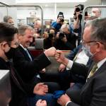 Michael van der Veen, second from left an attorney for former President Donald Trump, fist bumps a colleague as the depart on the Senate Subway, on Capitol Hill after the Senate acquitted Trump in his second impeachment trial in the Senate at the U.S. Capitol in Washington, Saturday, Feb. 13, 2021. Trump was accused of inciting the Jan. 6 attack on the U.S. Capitol, and the acquittal gives him a historic second victory in the court of impeachment. (AP Photo/Alex Brandon)