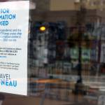 A sign posted by Travel Juneau notes the pamphlet-filled visitors center kiosk is closed because of the pandemic. The center, located near the downtown library, opened in May 2019 during Infrastructure Week. (Ben Hohenstatt / Juneau Empire File)