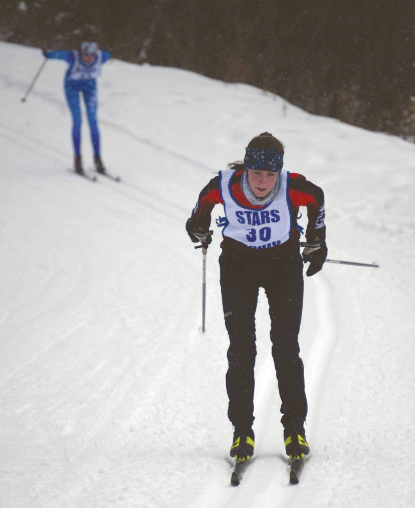 Kenai Centrals Jayna Boonstra leads Soldotnas Erika Arthur on Saturday, Feb. 20, 2021, at the Kenai Peninsula Borough ski championships at Tsalteshi Trails just outside of Soldotna, Alaska. (Photo by Jeff Helminiak/Peninsula Clarion)