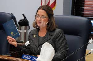 Alaska state Sen. Lora Reinbold, an Eagle River Republican, holds a copy of the Alaska Constitution during a committee hearing on Wednesday, Jan. 27, 2021, in Juneau, Alaska. Gov. Mike Dunleavy, a Republican, sent Reinbold a letter on Feb. 18, 2021, saying she has used her position to misrepresent the states COVID-19 response. Reinbold said the letter was full of baseless accusations and complaints. (AP Photo/Becky Bohrer)