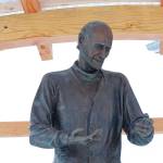 A statue of Brother Asaiah rests under a protective wooden structure on Thursday, Feb. 18, 2021 outside KBBI Public Radio in Homer, Alaska. (Photo by Megan Pacer/Homer News)