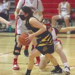 Homers Hannah Hatfield keeps the ball away from Kenai Centrals Logan Satathite and Michal Keyes on Thursday, March 4, 2021, at Kenai Central High School in Kenai, Alaska. (Photo by Jeff Helminiak/Peninsula Clarion)