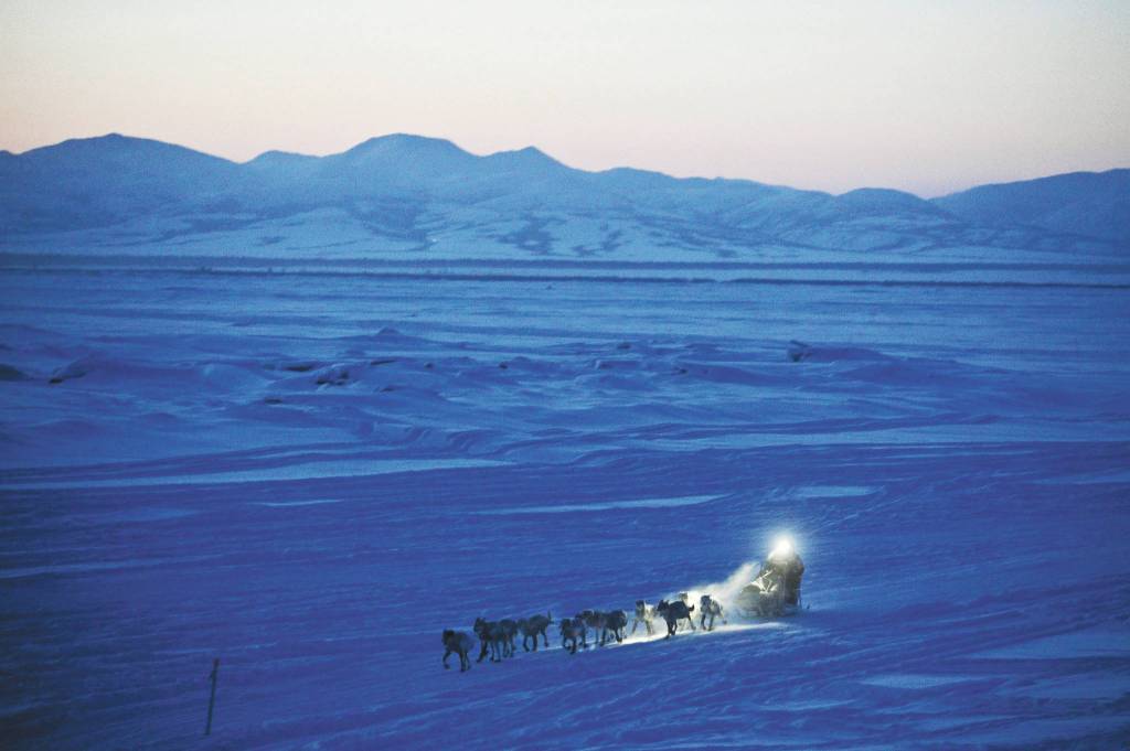 In this March 11, 2012, file photo, Dallas Seavey pulls in to the checkpoint in Unalakleet, Alaska, during the Iditarod Trail Sled Dog Race. The worlds most famous sled dog race starts Sunday, March 7, 2021, without its defending champion in a contest that will be as much dominated by unknowns and changes because of the pandemic as mushers are by the Alaska terrain. (Marc Lester/Anchorage Daily News via AP, File)