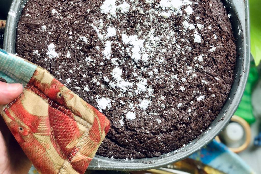 Kladdkaka sprinkled with powdered sugar is ready to be eaten, photographed on Tuesday, March 9, 2021, in Anchorage, Alaska. (Photo by Victoria Petersen/Peninsula Clarion)