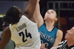 Nikiskis Bethany Carstens (right) and ACSs Jordan Todd tip off to begin the 2019 Class 3A girls state basketball championship at the Alaska Airlines Center in Anchorage. (Photo by Joey Klecka/Peninsula Clarion)