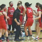 Head coach Jeff Swick and the Kenai Central girls basketball team celebrate earning a berth in the Class 3A state tounament after defeating Homer in the semifinals of the Southcentral Conference girls tournament Friday, March 12, 2021, at Nikiski High School in Nikiski, Alaska. (Photo by Jeff Helminiak/Peninsula Clarion)