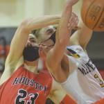 Houstons Hunter Jefferson and Homers Clayton Beachy battle for the rebound Saturday in the third-place game of the Southcentral Conference boys tournament at Kenai Central High School in Kenai. (Photo by Jeff Helminiak/Peninsula Clarion)