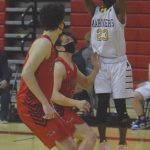 Homers Eyoab Knapp goes up for a jumper on Houstons Braden Cork and Brandon Hina on Saturday, March 13, 2021, in the third-place game in the Southcentral Conference boys tournament at Kenai Central High School in Kenai, Alaska. (Photo by Jeff Helminiak/Peninsula Clarion)