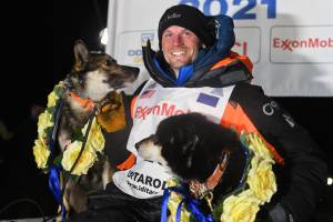 Dallas Seavey poses with his dogs after winning the Iditarod Trail Sled Dog Race race near Willow, Alaska, early Monday, March 15, 2021. (Marc Lester/Anchorage Daily News via AP, Pool)