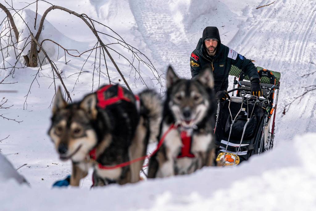 Richie Diehl mushes up the first part of the Happy River Steps on Sunday, March 14, 2021 during the Iditarod, in Alaska. The steps are normally a tricky downhill part of the race, but this year mushers are also doing it in reverse. (Loren Holmes/Anchorage Daily News via AP, Pool)