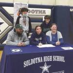 Soldotna senior Morgan Bouschor signs her National Letter of Intent on Wednesday, March 17, 2021, at Soldotna High School in Soldotna, Alaska. Bouschor is with her father, Jeffrey, her mother, Chrissy, and brothers Eli and Zack. (Photo provided)