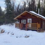A snowmachine at rest in front of the Snag Lake public use cabin. (Photo provided by USFWS)