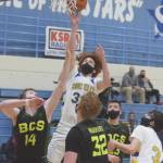 Cook Inlet Academys Mason Zeigler goes up for a shot against Birchwood Christians Tyler Huston at the Peninsula Conference tournament Thursday, March 18, 2021, at Soldotna High School in Soldotna, Alaska. (Photo by Jeff Helminiak/Peninsula Clarion)
