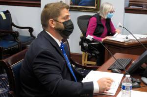 Adam Crum, commissioner of the Alaska state health department, testifies before a state Senate committee on Wednesday, Jan. 27, 2021, in Juneau, Alaska. (AP Photo/Becky Bohrer)