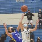 Lumen Christis Emily Ross drives to the basket on Cook Inlet Academys Hope Hillyer during the Peninsula Conference championship game Friday, March 19, 2021, at Soldotna High School in Soldotna, Alaska. (Photo by Jeff Helminiak/Peninsula Clarion)