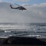 A U.S. Coast Guard helicopter helps ferry volunteers to the carcass of a beached humpback whale on Kuzof Island on Thursday, March 18, 2021. (Coutesy photo / Alaska Marine Mammal Stranding Network)