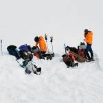In this photo provided by the Alaska Mountain Rescue Group, some of the groups volunteers work near the scene of a helicopter crash close to the Knik Glacier in Alaska on Sunday, March 28, 2021. Federal investigators say a helicopter carrying five passengers on a heli-skiing trip in Alaska crashed into a mountain and then rolled downhill nearly 900 feet. The pilot and four of the five passengers on board died in the crash, including billionaire Petr Kellner, the richest man in the Czech Republic. The National Transportation Safety Board is investigating the cause of the crash just north of Anchorage on Saturday night. (Lance Flint/Alaska Mountain Rescue Group via AP)