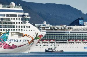A fishing vessel is dwarfed by the Norwegian Cruise Lines Norwegian Jewel and Norwegian Pearl in Juneaus downtown harbor in September 2014. A resolution urging federal action on maritime laws was held up by House Republicans with legal concerns. (Michael Penn / Juneau Empire File)