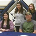 Soldotna senior Autumn Fischer signs her National Letter of Intent on Friday, March 26, 2021, at Soldotna High School in Soldotna, Alaska. Next to Autumn is her father, Eric Fischer. In the back row is mother, Judith Fischer, and sister, Brook Fischer. (Photo provided)