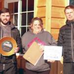 Soldotna's Travis Temple and Chad Moore accept awards from Cindi Herman of Skwentna Roadhouse after the 5th Annual Skwentna XC Snowmachine Race on Saturday, March 27, 2021. (Photo provided)