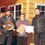 Soldotnas Travis Temple and Chad Moore accept awards from Cindi Herman of Skwentna Roadhouse after the 5th Annual Skwentna XC Snowmachine Race on Saturday, March 27, 2021. (Photo provided)