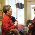 Rep. Sarah Vance, R-Homer, left, speaks with Robert Archibald, right, before holding a town hall meeting on Monday, March 29, 2021, at Captains Coffee in Homer, Alaska. Archibald was only one of four people who wore face masks at the event of about 55 people. (Photo by Michael Armstrong/Homer News)