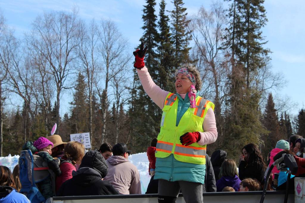 Carol Bannock directs families to an Easter egg hunt at Kenai Municipal Park on Friday, April 2, 2021 in Kenai, Alaska. (Ashlyn OHara/Peninsula Clarion)