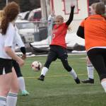 Kenai Centrals Karley Harden attacks the Nikiski net Thursday, April 15, 2021, at Kenai Central High School in Kenai, Alaska. (Photo by Jeff Helminiak/Peninsula Clarion)