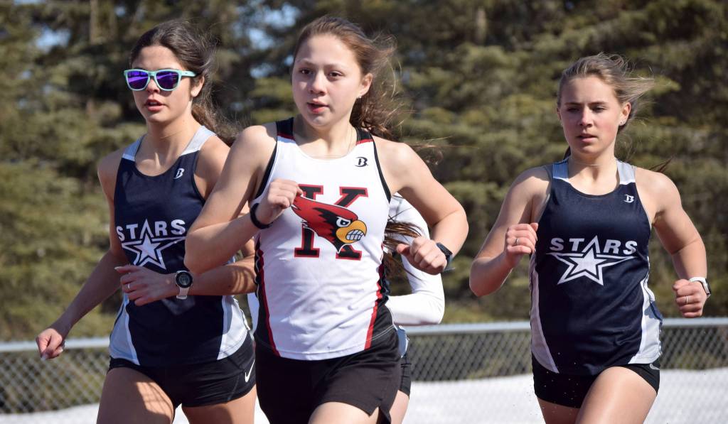Kenai Centrals Emilee Wilson leads Soldotnas Erika Arthur and Jordan Strausbaugh during the 800-meter run during a dual meet Friday, April 16, 2021, at Kenai Central High School in Kenai, Alaska. (Photo by Jeff Helminiak/Peninsula Clarion)