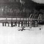 This 1923 Alaska Road Commission photo shows the original bridge over Schooner Bend on the Kenai River, before it took on its more familiar appearance as a covered bridge. The wooden bridge, erected in 1920, was dismantled in the 1950s after a steel span located downstream replaced it.