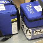 In this photo provided by Norton Sound Health Corp., are coolers containing Pfizer COVID-19 vaccines for the rural Alaska communities of Savoonga and Gambell being weighed at an air terminal in Nome, Alaska, on Jan. 14, 2021. Some of Alaskas highest vaccination rates among those 16 or older have been in some of its remotest, hardest-to-access communities, where the toll of past flu or tuberculosis outbreaks hasnt been forgotten. (Reba Lean/Norton Sound Health Corp. via AP)