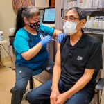 In this photo provided by Norton Sound Health Corp., is nurse LaVerne Saccheus providing a vaccination to Unalakleet elder Joseph Nupid Katchatag in Unalakleet, Alaska, on Dec. 23, 2020. Alaskas highest vaccination rates among those 16 or older have been in some of its remotest, hardest-to-access communities, where the toll of past flu or tuberculosis outbreaks hasnt been forgotten. (Carol Charles/Norton Sound Health Corp. via AP)