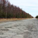 Potholes are seen on Wildwood Drive on Thursday, April 22 in Kenai, Alaska. (Ashlyn OHara/Peninsula Clarion)