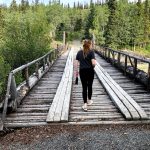 Camille Botello crosses a bridge with her bear spray in a rest stop area off the Alaska Highway on July 17, 2020. (Photo provided)