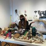Artist-in-residence Emily Schubert makes sense out of her materials-covered desk on April at Bunnell Street Arts Center.