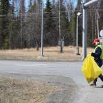 Friends of Alaska National Wildlife Refuge Vice President and Outreach Chair Poppy Benson collects litter from the side of the highway at the refuge in Soldotna, Alaska on Friday, April 30, 2021. (Camille Botello / Peninsula Clarion)