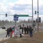People protest outside of the Kenai Chamber of Commerce and Visitor Center on Wednesday, May 5, 2021 in Kenai, Alaska. (Ashlyn OHara/Peninsula Clarion)