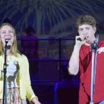 Camry Ellis (left) and Braeden Porter sing onstage as their characters Gabriella Montez and Troy Bolton in the Nikiski Middle/High Schools spring production of High School Musical in Nikiski, Alaska, on Wednesday May 5, 2021. (Camille Botello / Peninsula Clarion)