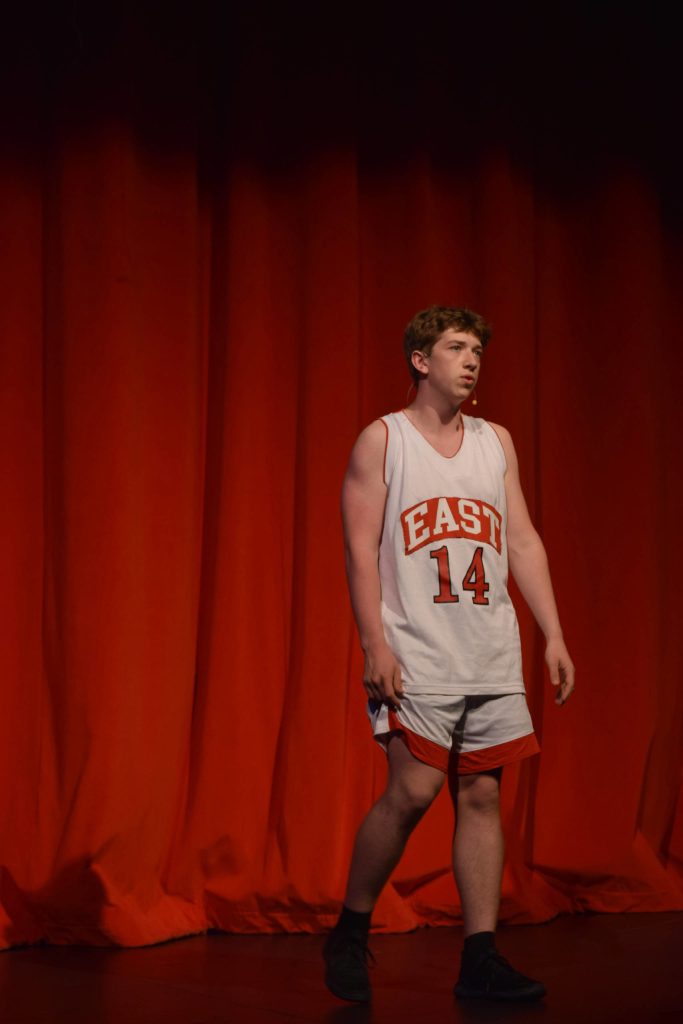 Braeden Porter sings onstage as his character Troy Bolton in the Nikiski Middle/High Schools spring production of High School Musical in Nikiski, Alaska, on Wednesday May 5, 2021. (Camille Botello / Peninsula Clarion)