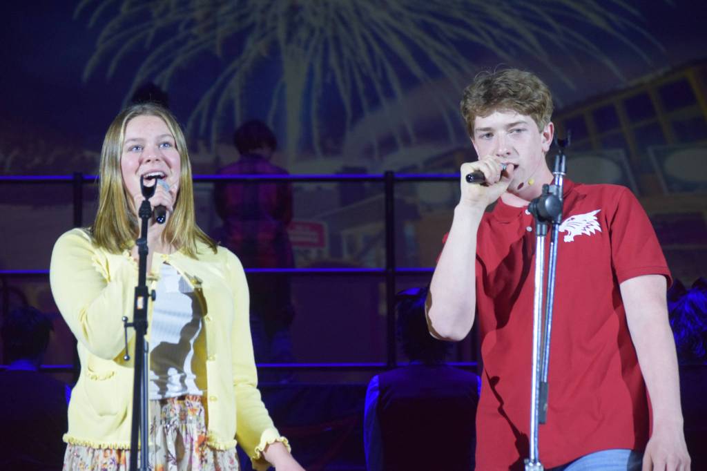 From left to right: Camry Ellis and Braeden Porter sing onstage as their characters Gabriella Montez and Troy Bolton in the Nikiski Middle/High Schools spring production of High School Musical in Nikiski, Alaska, on Wednesday May 5, 2021. (Camille Botello / Peninsula Clarion)