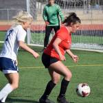 Kenai Central defender Valerie Villegas keeps the ball from Homer's Sela Weisser in front of Kenai goalie Emma Beck on Thursday, May 6, 2021, at Kenai Central High School in Kenai, Alaska. (Photo by Jeff Helminiak/Peninsula Clarion)