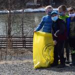 From left to right: Soldotna Montessori elementary schoolers Augie Mohr, Corbin Sulley, Nathan Nelson and Kian Jester participate in the annual Kenai River Spring Cleanup at Soldotna Creek Park in Soldotna, Alaska, on Friday, May 7, 2021. (Camille Botello / Peninsula Clarion)