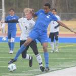 Kenai Centrals Leif Lofquist and Soldotnas Maleda Denbrock challenge for the ball Tuesday, May 11, 2021, at Soldotna High School in Soldotna, Alaska. (Photo by Jeff Helminiak/Peninsula Clarion)