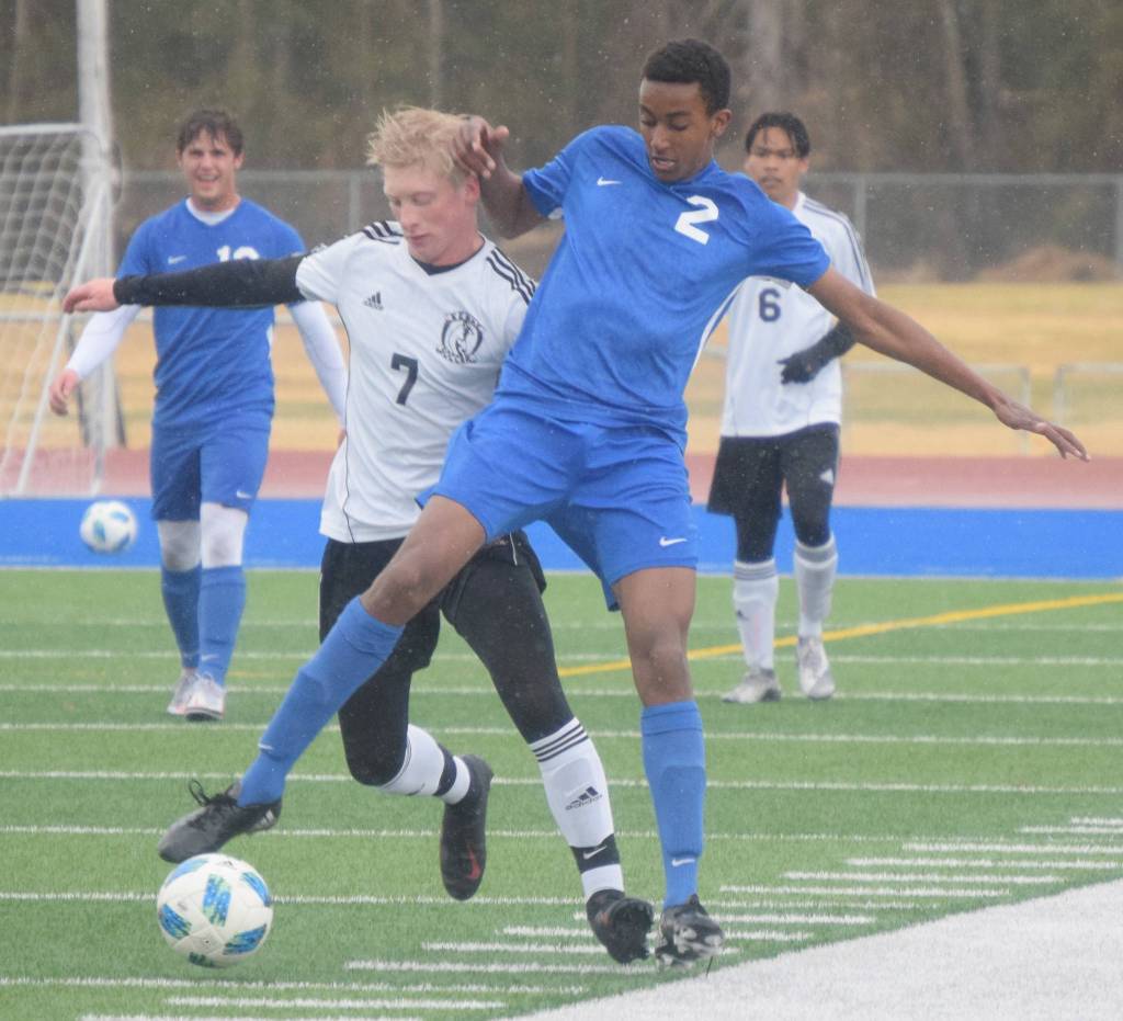 Kenai Centrals Leif Lofquist and Soldotnas Maleda Denbrock challenge for the ball Tuesday, May 11, 2021, at Soldotna High School in Soldotna, Alaska. (Photo by Jeff Helminiak/Peninsula Clarion)