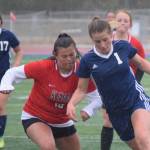 Soldotna's Rhys Cannava dribbles in for a goal against Kenai Central's Valerie Villegas on Tuesday, May 11, 2021, at Soldotna High School in Soldotna, Alaska. (Photo by Jeff Helminiak/Peninsula Clarion)