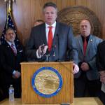 Alaska Gov. Mike Dunleavy speaks during a news conference on Wednesday, May 12, 2021, in Juneau, Alaska, with a number of state legislators around him. Dunleavy discussed a proposed constitutional amendment dealing with the Alaska Permanent Fund and the Permanent Fund dividend. (AP Photo/Becky Bohrer)